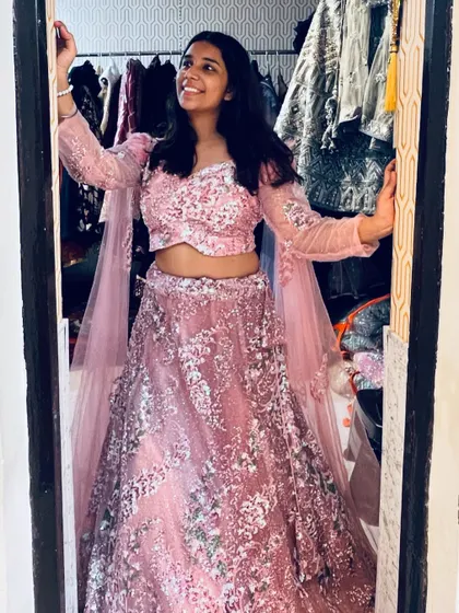 A happy client trying on the pink sequin lehenga in the store. It’s always a joy to see someone find their perfect party outfit.