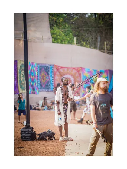 A portrait that contains the "humanity of the moment." This candid shot of a festival-goer is a character study, capturing his unique style and presence.