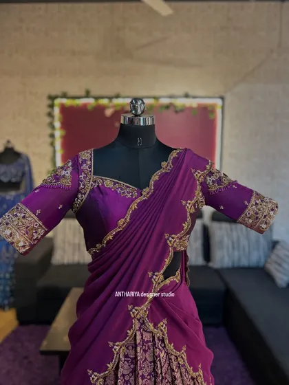 A close-up of the heavily embroidered sleeves and sweetheart neckline of the purple langa voni blouse.