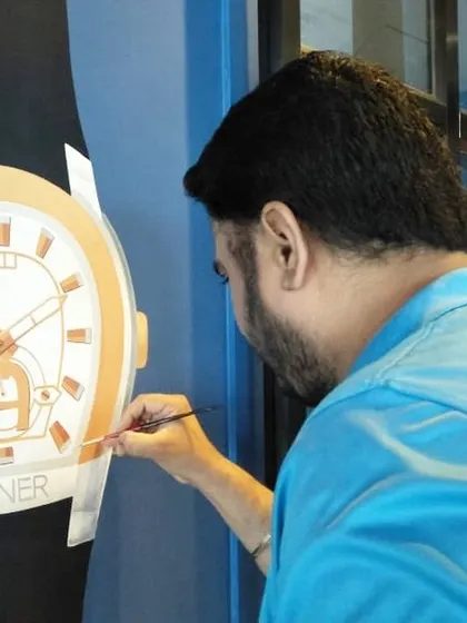 Here I am adding the final details to a large, hand-painted Aigner watch mural. This kind of detailed product artwork is a great way for a brand to showcase its flagship items in its office or showroom.