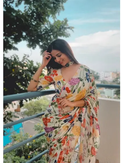 A smiling portrait in the floral chiffon saree, looking effortlessly chic.
