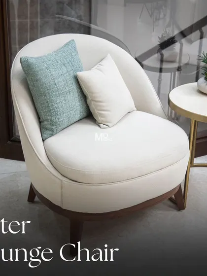 The Aster lounge chair, draped in smooth, ivory upholstery that invites you to unwind. Its low-profile silhouette and subtle curves bring understated elegance, perfect for creating a cozy and chic living space.