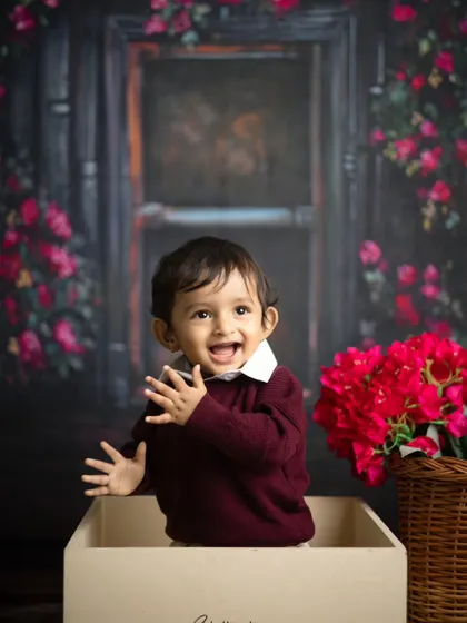 Waving at the camera! This shot captures the playful and interactive nature of a toddler milestone session.