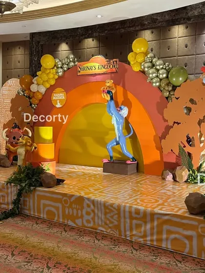 A side view of the grand Lion King stage, highlighting the detailed character cutouts and the layered rainbow backdrop.