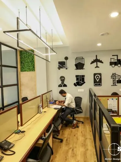 This collaborative workspace features custom wall art reflecting the company's logistics business. We used glass partitions and shared desks to create an open, energetic environment that fosters communication.