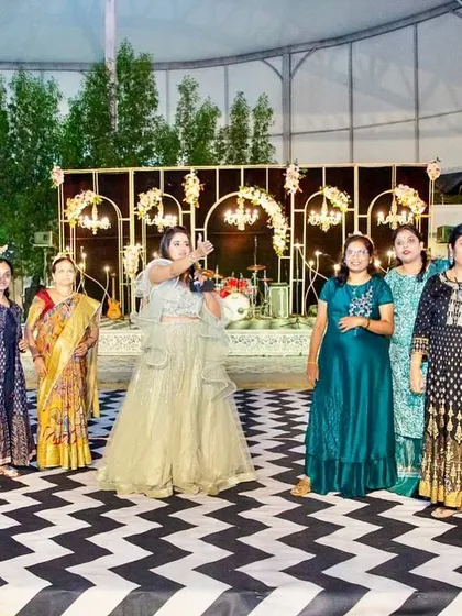 Another happy group shot on the chevron dance floor, with the beautiful stage decor visible in the background.