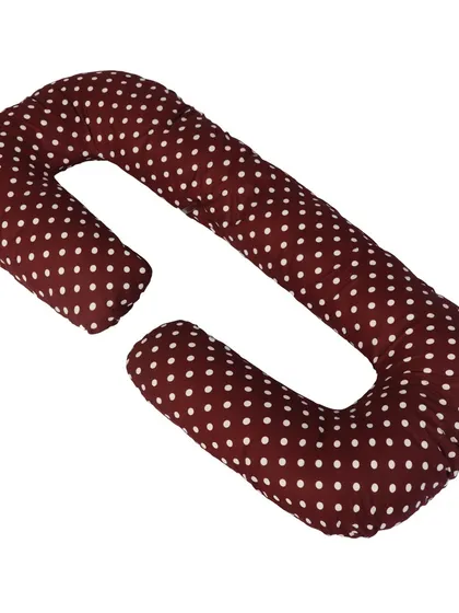 A C-shaped pregnancy pillow in maroon polka dot, with its detachable section shown.
