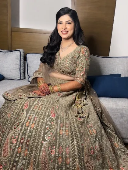 A portrait of Nikita's Sangeet look. She looks poised and elegant, with makeup that enhances her features beautifully.