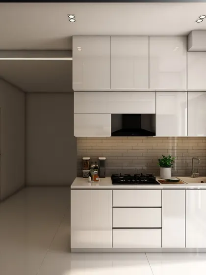 The main cooking area of the white kitchen, featuring a built-in hob, chimney, and handleless cabinets that contribute to the sleek aesthetic.