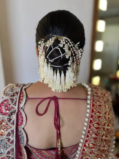 A stunning bridal hair accessory with pearl tassels, creating a very grand and traditional look for the main wedding day.