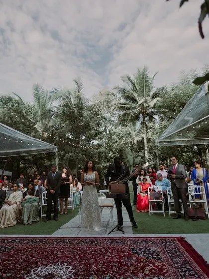 A beautiful outdoor ceremony setup with clear-top tents, allowing guests to enjoy the sky while being shaded from the sun.