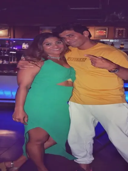A couple posing on the dance floor, enjoying the music and the party atmosphere.