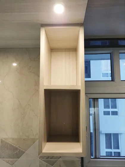 An open shelving unit integrated into the overhead cabinets, perfect for storing frequently used items or displaying decorative pieces. The spotlight adds a touch of warmth.