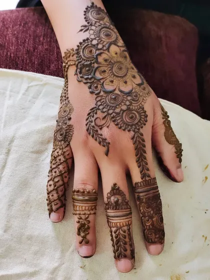 A single-hand view of an intricate design, showing the detailed work on the fingers and back of the hand.