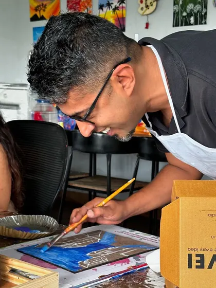 A participant carefully painting a section of his puzzle. The process requires both a big-picture vision and attention to the small details of each piece.
