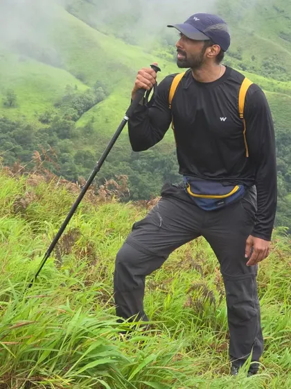 A full-length shot during the trek, equipped with my backpack and trekking pole.