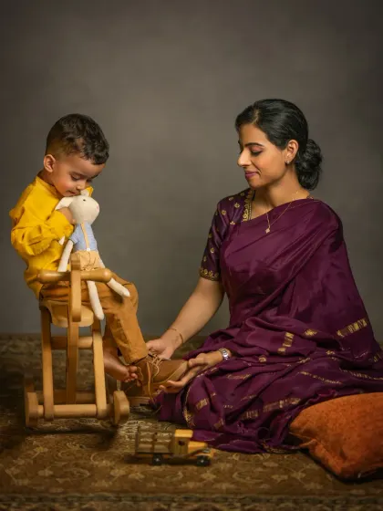A storybook session can also be a beautiful setting for a mother-child portrait. Here, a mother and her toddler share a quiet moment, a scene that tells a story of love and the challenges of modern motherhood.