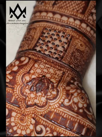 A macro shot of the intricate details in a bridal mehendi, showing the fine lines and patterns.