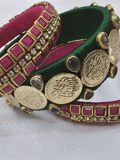 Another detailed shot of the green and pink bangles, focusing on the craftsmanship of the coin and stone work.