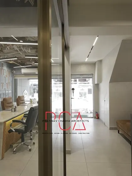 An alternate view of the conference room and adjacent corridor at StyleIn Homes, showcasing the cohesive design language across different zones.