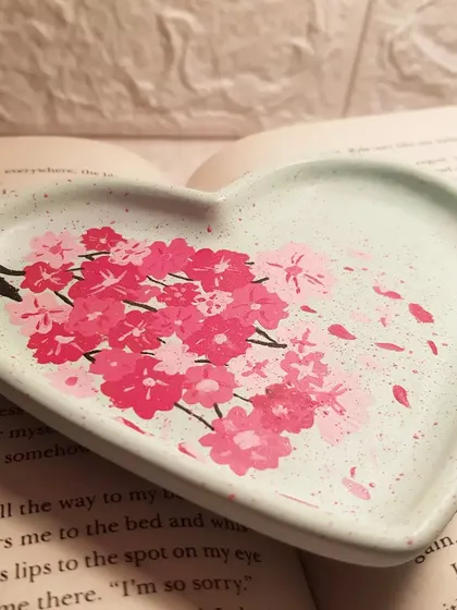 We spent over an hour hand-painting the cherry blossoms on this mint green heart tray. It’s a labor of love, designed to be a unique piece of art for your home.