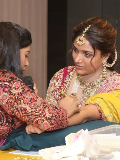 Demonstrating a bridal design on a model during a professional seminar. These events are a great way to connect with other artists.