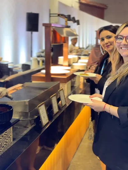 Guests enjoying the buffet at a corporate event. We design our buffet layouts to be user-friendly and visually appealing, encouraging guests to explore the culinary offerings.