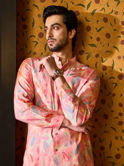 A closer look at the popping pink kurta, showing the detail in the print and the texture of the fabric. It's a piece that reflects a joyful and modern approach to festive dressing.