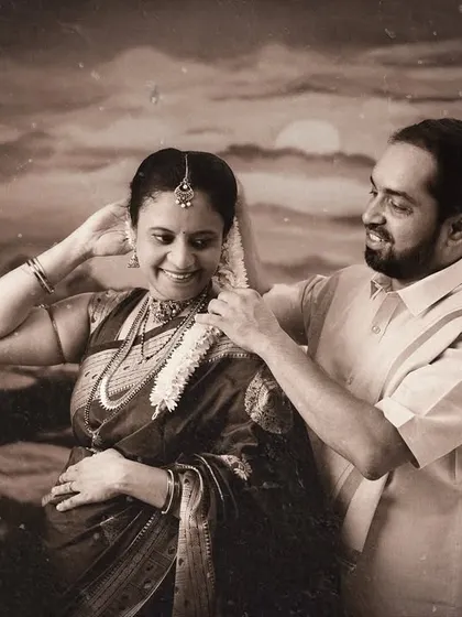 A vintage-style black and white photo of a couple sharing a tender moment. This sepia-toned image feels like a cherished memory from a classic film.