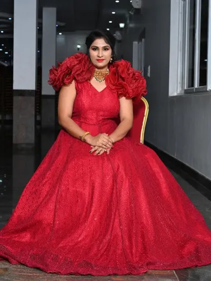 Our client Shruthi looking stunning in a dramatic red gown with ruffled shoulders for her son's birthday bash.