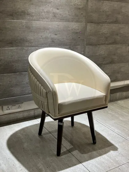 With its barrel-back design and pleated detailing, this cream-colored chair is a sophisticated seating option. The solid wood legs provide a sturdy and stylish base.