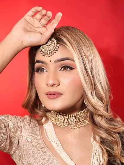 This angle highlights the sharp winged liner and the soft contouring that defines her features. It's a modern yet timeless look for any day bride.