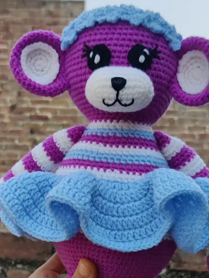 A close-up of the custom-colored monkey doll, featuring a cute frilly skirt.