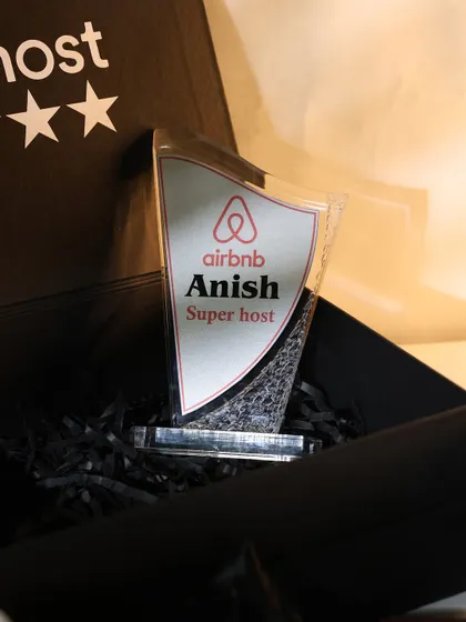 A close-up of the personalized "Super Host" acrylic trophy I designed for an Airbnb host. It's a unique and lasting way to recognize outstanding performance.