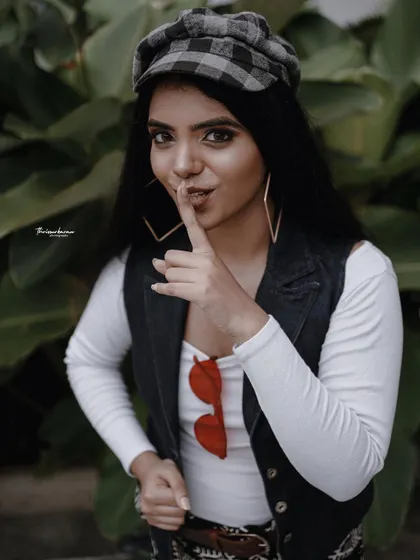 A playful portrait of the female model from the "Western Lungi Look" shoot, adding a fun and mysterious vibe.