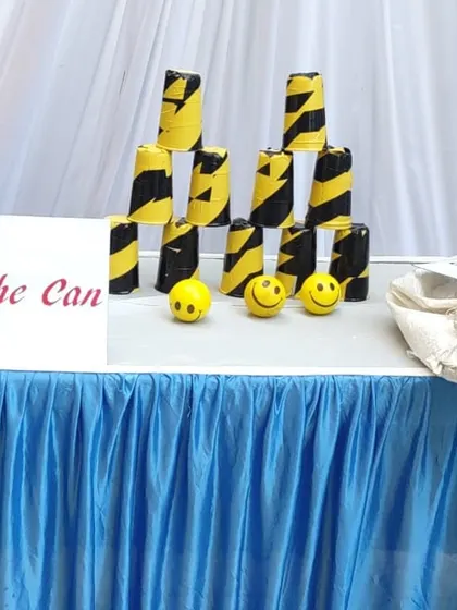 The 'Knock the Can' game is a simple but challenging classic. I provide the stacked cans and soft balls for players to test their aim and strength.