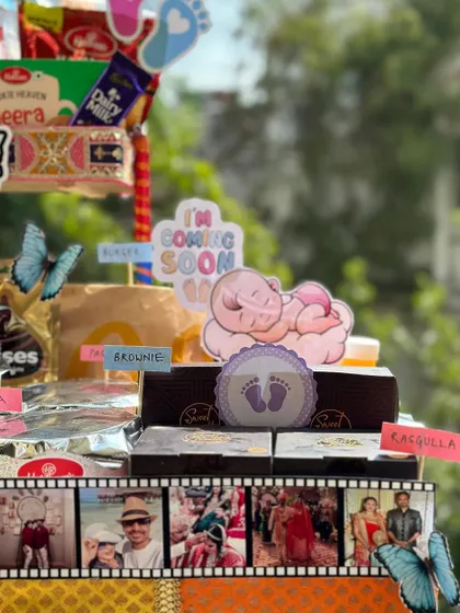 This shot highlights the personalized filmstrip detail on the parents-to-be food hamper. I use your photos to create a timeline of memories, adding a deeply personal touch to the gift.