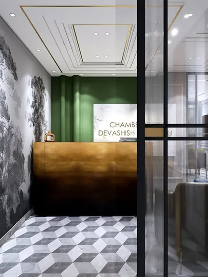This angle shows the glass partition separating the reception from the main office, maintaining an open feel while providing necessary privacy. The design is both elegant and functional.