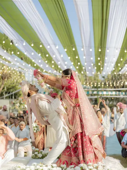 The varmala isn't just a ritual; it's a playful battle of love. I'm always ready to capture these fun, unscripted moments that show your unique chemistry and the pure joy of your shaadi.
