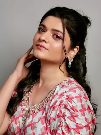 Another angle of the vibrant pink eye makeup, showing confidence and skill.