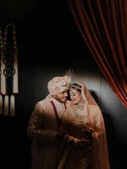 A quiet, intimate portrait of the bride and groom. Amidst the grand celebrations, we ensure there are spaces and moments for the couple to connect, captured beautifully by their photography team.