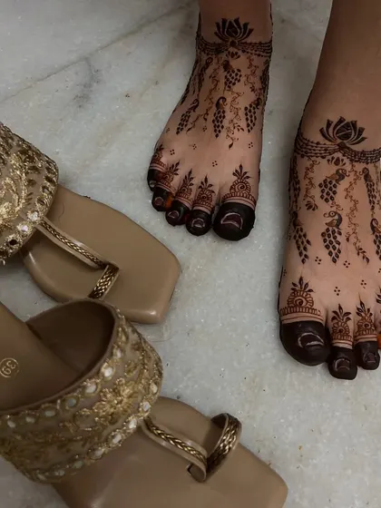 This shot shows how beautifully the mehendi complements traditional footwear, completing the entire look.