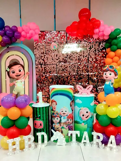 This Cocomelon setup for Tara's birthday is bursting with color. We used a rainbow of balloons, a pink sequin wall, and multiple character cutouts to create a playful and exciting party atmosphere.