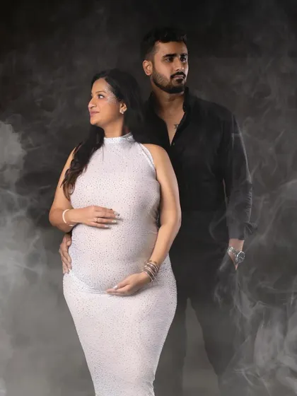 A strong and stylish couple's portrait with a dramatic smoky background, highlighting their partnership.
