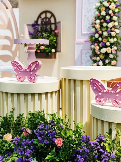 Close-up of the cake display stands, adorned with sweet butterfly details. Even the smallest elements are themed to perfection to ensure a cohesive and magical look.