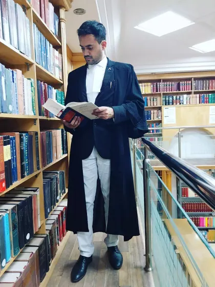 In the law library, surrounded by centuries of legal knowledge. Thorough research is the backbone of every strong case I build for my clients.