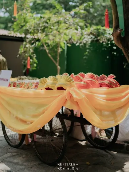 A decorated cart with wedding favors for guests, such as these colorful turbans.
