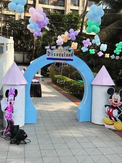 Welcome to Disneyland! This entrance arch with castle turrets and Mickey and Minnie Mouse cutouts is the perfect way to greet guests.