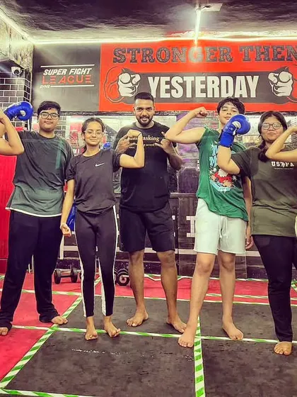 Team Jamshed Khan. A group of our teen students, flexing and showing the results of their training.