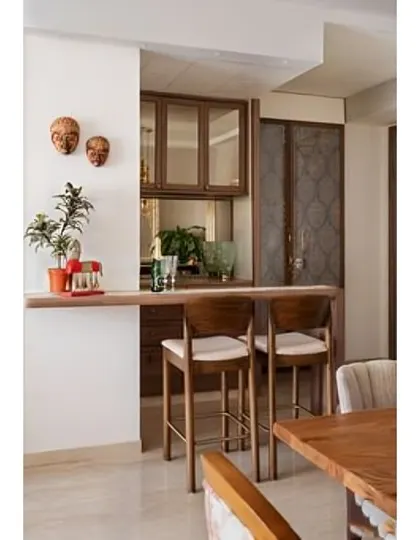 This design features a simple wooden breakfast bar that extends into the dining area. It's a space-efficient solution that connects the kitchen and living spaces.